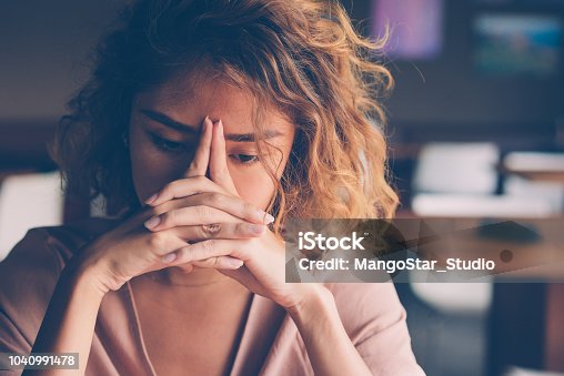 istock Tired Young Woman Leaning Head on Hands 1040991478