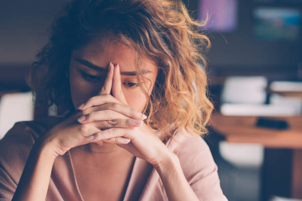 tired young woman leaning head on hands - stress stock photos and pictures