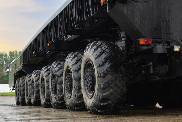 Tires of the heavy duty truck for transport missile defence system and oversized cargo. Wheeled chassis of a military transporter. stock photo