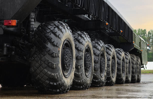 Tires of the heavy duty truck for transport missile defence system and oversized cargo. Wheeled chassis of a military transporter. stock photo