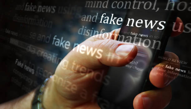 Titles on screen in hand with fake news and hoax information 3d illustration stock photo