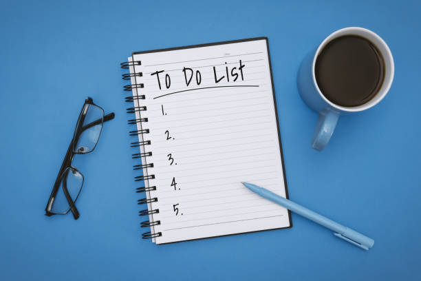 To Do List on Notebook over Pastel Blue Background Overhead View of To Do List on Notebook over Pastel Blue Background to do list stock pictures, royalty-free photos & images