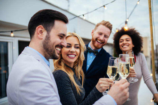 A toast to love and friendship ! Group of friends celebrating with Champagne high society stock pictures, royalty-free photos & images