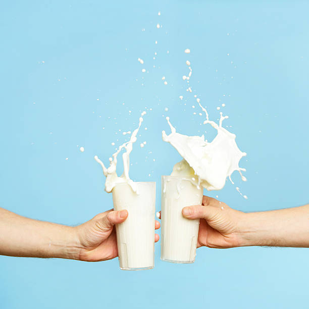 toasting with milk glass - melk stockfoto's en -beelden