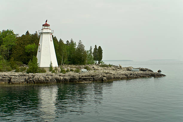 Tobermory Lighthouse View of Tobermory Lighthouse from passing boat. bruce springsteen stock pictures, royalty-free photos & images