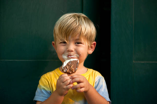 toddler enjoying ice cream stock photo