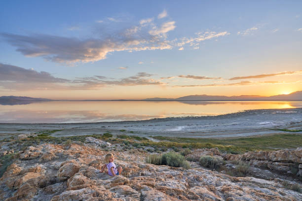 Toddler Girl Enjoying the Breathtaking Sunrise in the Beautiful 
Antelope Island State Park Near Salt Lake City, UTAH USA stock photo