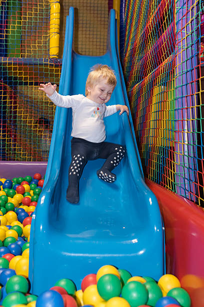 Toddler on a slide stock photo