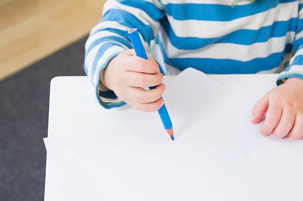 Toddler showing a poor pencil grip stock photo