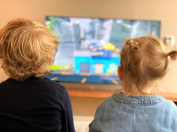 Toddlers watching tv stock photo