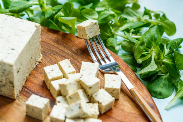 Tofu sliced on a wooden board. stock photo