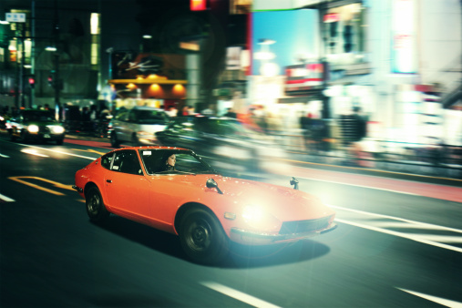 Night pursuit in an oldtimer sportscar on the streets of Shinjuku, Tokyo.