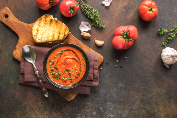 Tomato Soup with grilled cheese Tomato Soup with grilled cheese sandwich, top view, copy space. Homemade tomato soup with thyme. comfort food stock pictures, royalty-free photos & images