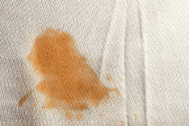 Tomato stain on white cloth stock photo