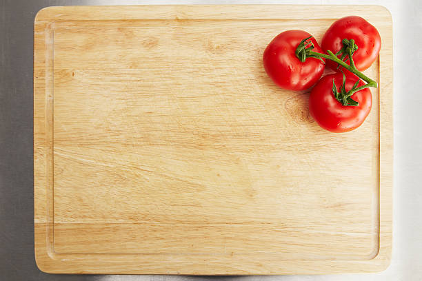 Tomatoes on a chopping board stock photo