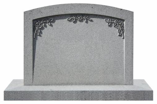 isolated granite tombstone with flowers