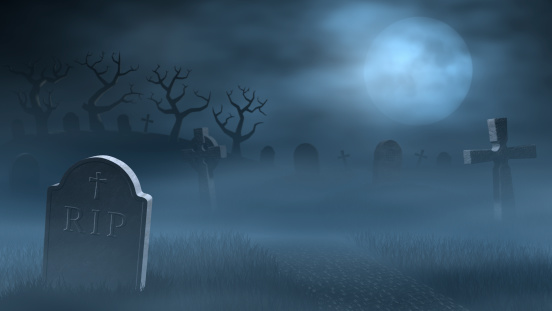 A foggy graveyard at full moon.