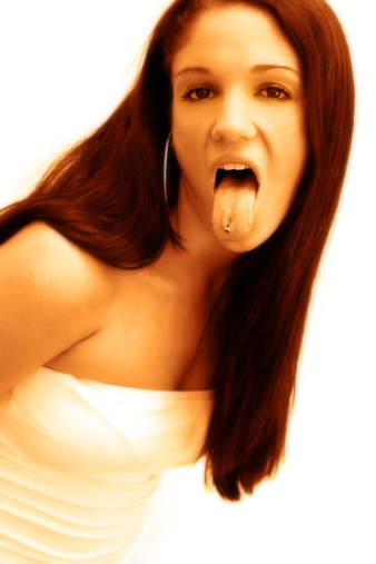 Young woman with a stud in her tongue.