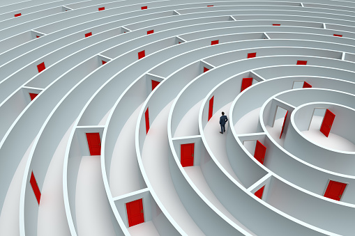 The concept of difficulty, too many options in a huge maze, Businessman looking for the right way to success, 3D - Computer generated image.