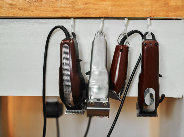 Tools of the trade Cropped shot of a group of electric hair shavers hanging on walled hooks in an empty salon hook equipment stock pictures, royalty-free photos & images