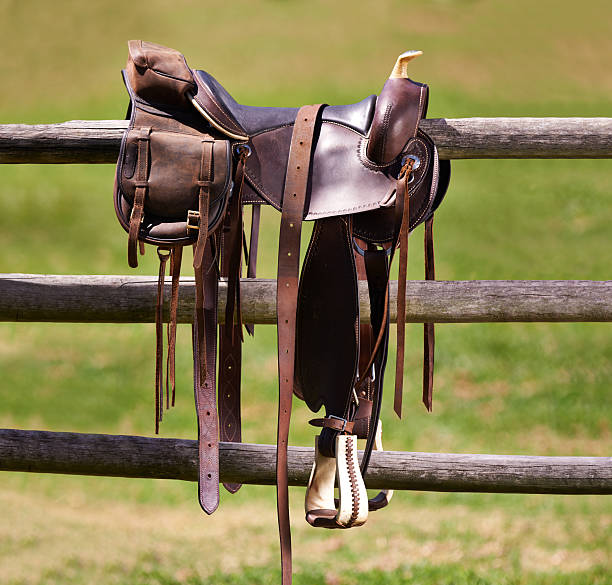 Tools of the trade Shot of a saddle on a fence saddle stock pictures, royalty-free photos & images