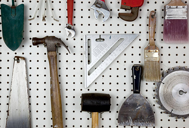 Tools Various tools organized on a white pegboard. pegboard stock pictures, royalty-free photos & images