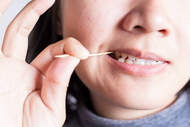 Toothpick her Teeth stock photo