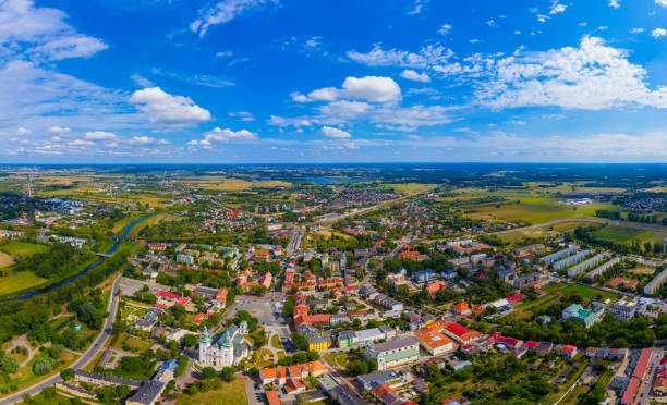 Top aerial panoramic view of Lowicz old town historical city centre with Rynek Market Square, Old Town Hall, New City Hall, colorful buildings with multicolored facade and tiled roofs, Poland stock photo
