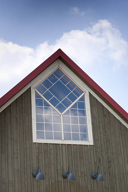 Top of A-frame building with custom window stock photo