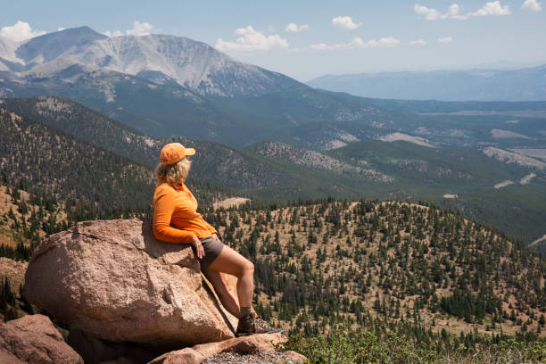 Top of Monarch Crest Woman relaxing on a boulder at the top of Monarch Crest in the Rocky Mountains, Monarch Crest, Salida, CO, USA salida colorado stock pictures, royalty-free photos & images