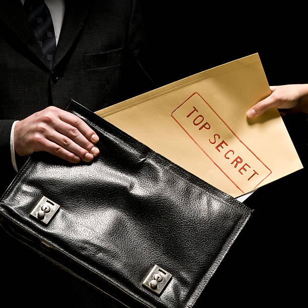 Top Secret Businessman passing secret documents. top secret stock pictures, royalty-free photos & images