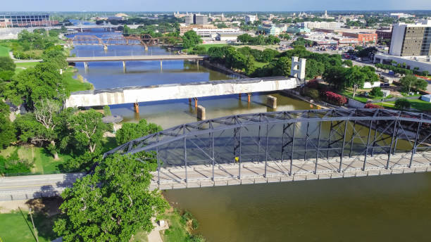 Top view four bridges including vehicular, Railway and  Suspension Bridge cross the Brazos River in downtown Waco, Texas stock photo