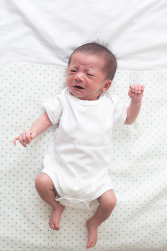 Top View Of Asian Baby Boy Lying On White Bed Crying And ...