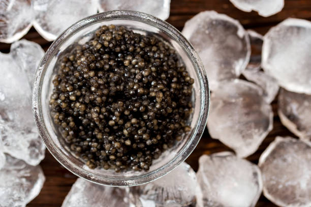 Top view of black surgeon or beluga caviar on wooden table stock photo