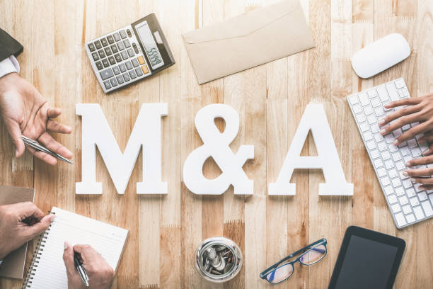 Top view of business office workstation with M&A letters or merger and acquisition stock photo