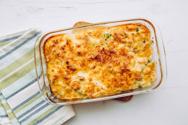 Top view of cauliflower, broccoli and cheese casserole in rectangular shape glass baking dish. Top view of cauliflower, broccoli and cheese casserole in rectangular shape glass baking dish. casserole dish stock pictures, royalty-free photos & images