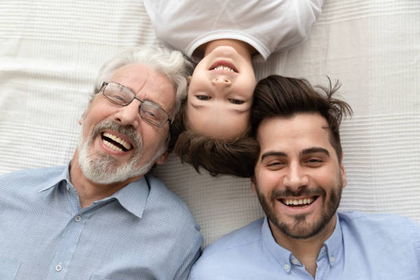 top visning av lyckliga tre generationer av män leende - far och son bildbanksfoton och bilder