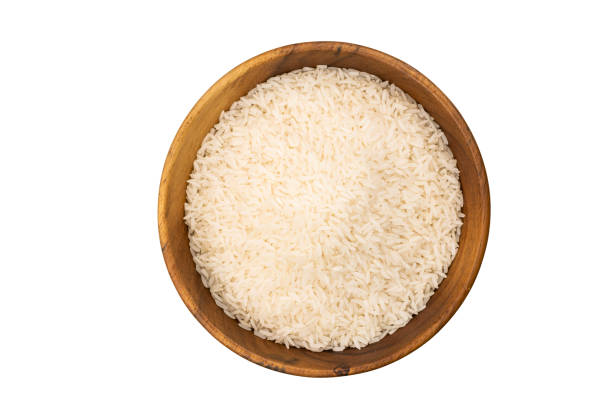 Top view of Jasmine Rice in a wooden bowl . stock photo