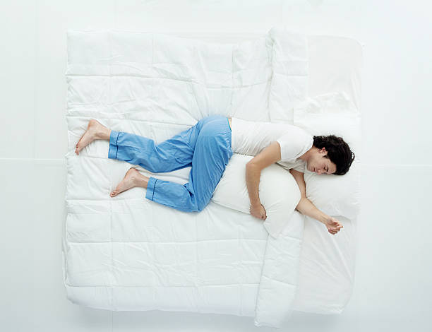Top view of man sleeping on bed Top view of man sleeping on bedhttp://www.twodozendesign.info/i/1.png man sleeping in bed top view stock pictures, royalty-free photos & images