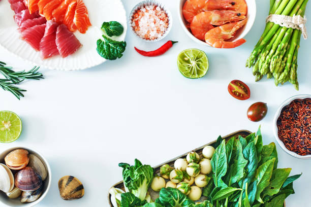 royalty free ingredients for cooking raw food flat lay pictures top view of salmon and tuna sashimi cooked shrimps clamps brown rice a green food background