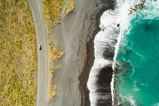 Top view of sea, waves and road in Wairarapa Region, North Island, New Zealand.