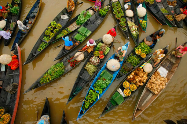 Top view of sellers on the boats at floating market, at Banjarmasin Indonesia in a bright morning. stock photo