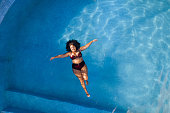 istock Top view of woman relaxing in swimming poll 1388009263