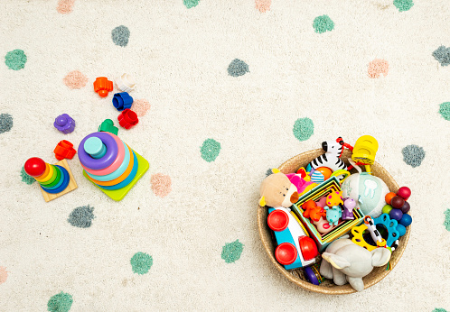 Top view on Colorful Baby Toys on a Carpet Background Toys in the floor with Copy Space for Text