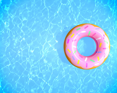 Top view summer background. Inflatable rubber donut ring floating on blue water in swimming pool with copy space, 3d rendering.