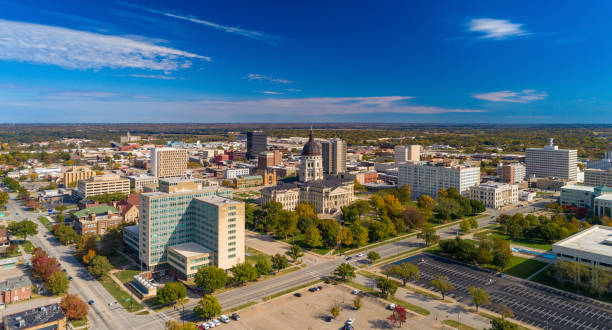 Topeka Aerial Skyline View With State Capitol Building Downtown Topeka aerial skyline view with the Kansas State Capitol building in the center, and a blue sky with clouds in the background. topeka stock pictures, royalty-free photos & images