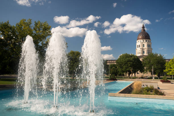 Topeka Kansas Capital Capitol Building Fountains Downtown City Skyline Soft clouds and blue skies appear over fountains and the capitol of Topeka, Kansas USA topeka stock pictures, royalty-free photos & images