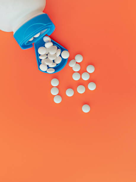 topview of melatonin tablets flying from the jar. dietary concept. dietary supplement close-up stock photo