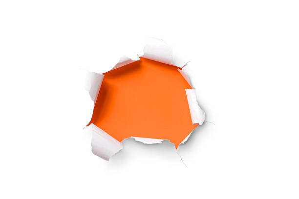 Torn paper hole. Tearing Inside Discovery through Emergence Orange White torn paper over orange background. appearance stock pictures, royalty-free photos & images