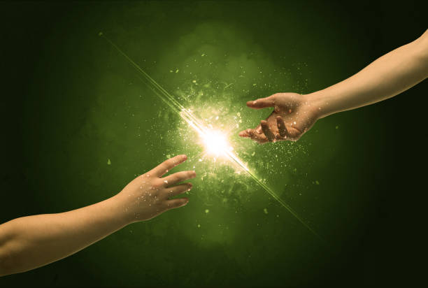 Touching arms lighting spark at fingertip stock photo